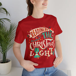 Reading by a Christmas Light Unisex Jersey Christmas Holiday Shirt For Readers